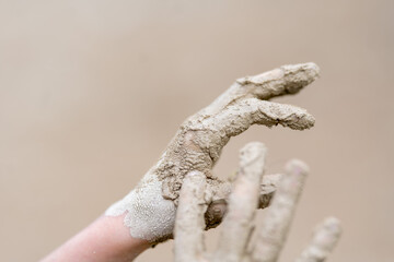 close up of kids hands with mud on it