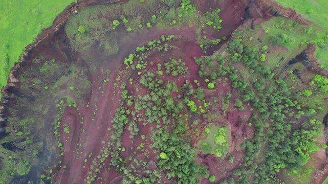 Racos volcano in Brasov, Romania: Top down drone shot revealing the textures and colors of the Racos extinct volcanic crater