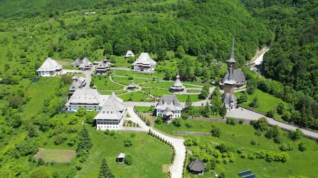 High angle drone footage capturing the orthodox Barsana Monastery complex in Romania during springtime