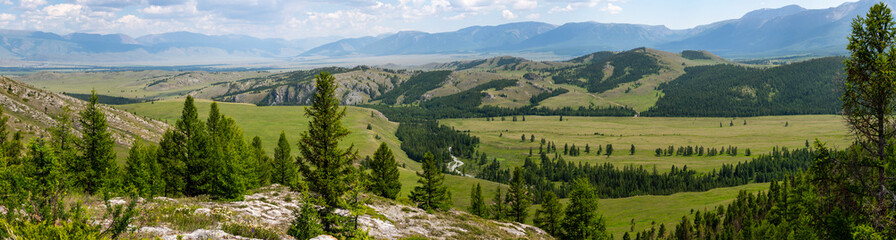 Panoramic view of the mountain ranges, spacious valley and pine forests
