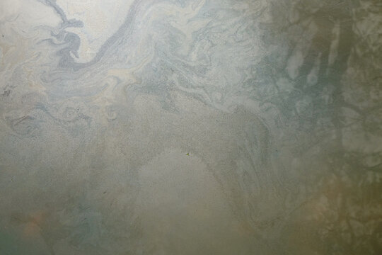 Abstract textured background of oily river water surface.Ecology and environmental concept. Water pollution. For graphic design, banners and 3D rendering