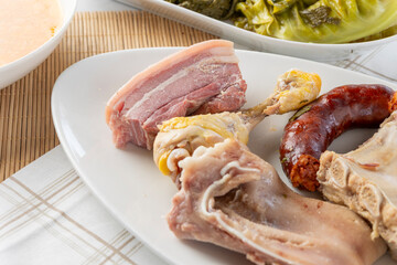 Cocido madrileño serving various meats and chorizo