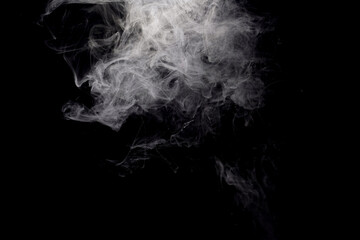Abstract smoke rising gracefully, creating a dark and dramatic background.