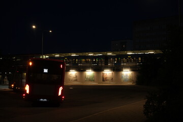 Bus and subway station Fru&auml;ngen at night, with mosaic wall art.