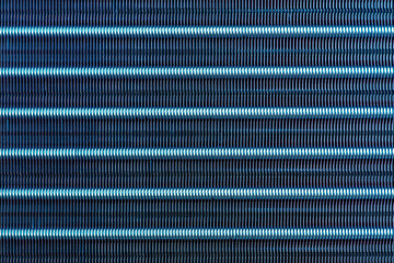 Abstract blue textured metallic background - air conditioner radiator grille.