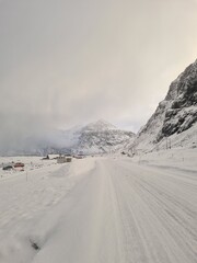 Winter road over the sea with snowy peak on Lofoten Islands, Norway. Travel background
