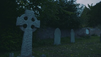 Gravestone in churchyard at dusk