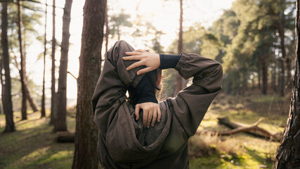 Girl warming up for a run in the woods