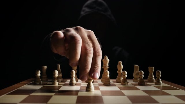 Dramatic Close-up of Chess Pieces being Moved by Mysterious Player Under Soft Light Depicting Intelligence, Strategic Thinking, Risk Management, Decision Process and Abstract Concept of Mind Games and