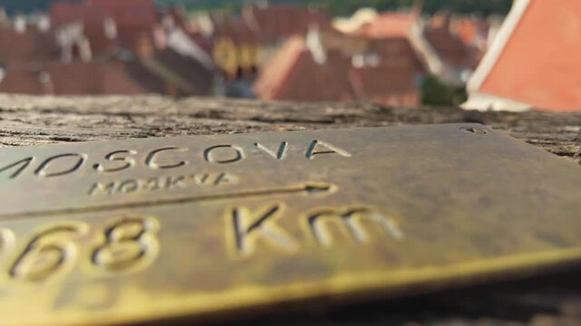 Close-up of a brass plate indicating the distance to Moscow, Russia from the Clock Tower in Sighișoara, Romania.