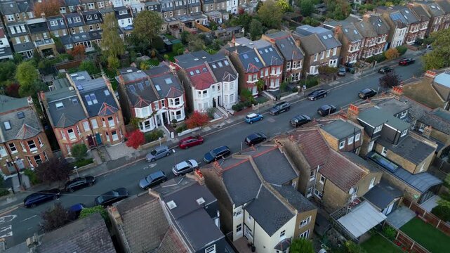 Top down drone flyover Wimbledon traditional British suburban houses in a row on quiet residential street