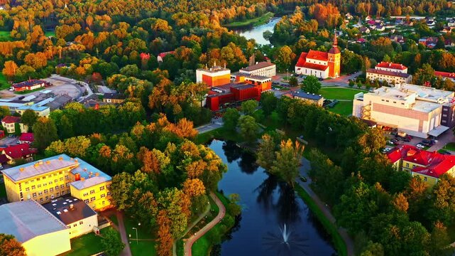 Valmiera Park Promenade During Autumn Season Near Dzirnavu Ezeriņ&scaron; And St. Simons Church In Latvia. Aerial Drone Shot