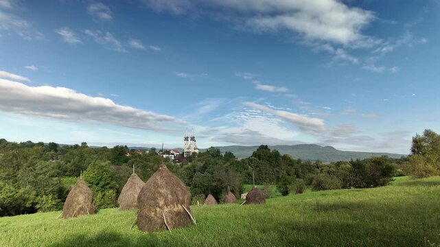 Conical haystacks in rural sunny day landscape, Breb village Romania