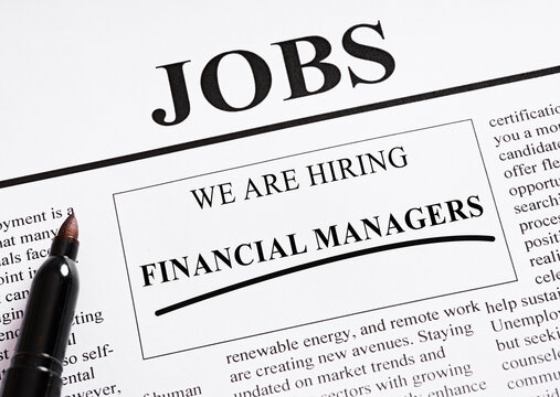 Hiring financial managers: newspaper with job advertisement showing open positions - Powered by Adobe