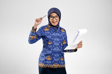 Cheerful Beautiful female civil servant in Korpri uniform holding pen and paper with a bright idea...