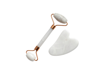 A jade roller and a gua sha tool, both designed for facial massage and skincare, featuring elegant gold accents and smooth surfaces.
