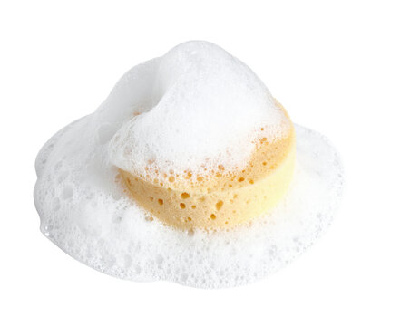 A yellow sponge covered with white foam, showcasing its porous texture and bubbly surface.