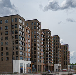 Modern residential apartment buildings in Stockholm under cloudy summer sky.