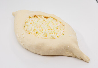 Fresh Cheese Stuffed Adjarian Khachapuri Dough Pocket Ready For Baking On White Surface
