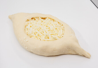 Fresh Cheese Stuffed Adjarian Khachapuri Dough Pocket Ready For Baking On White Surface