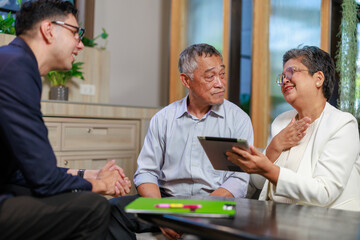 Fototapeta premium senior asian couple meeting financial advisor in modern office shaking hands after successful business discussion showing trust partnership communication and retirement planning consultation
