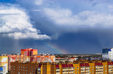 Amazing cloudy landscape above multi-colored residential buildings