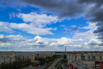 Panoramic cityscape with clouds and apartments