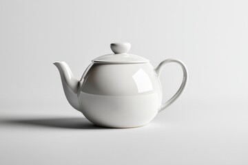 Elegant white ceramic teapot displayed on minimalist surface studio setting product photography clean background artistic perspective