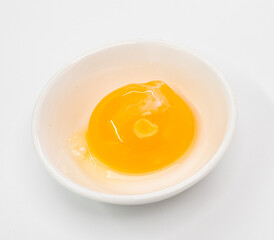 Bright Raw Egg in White Bowl On White Studio Background, Fresh Breakfast Ingredient Photography