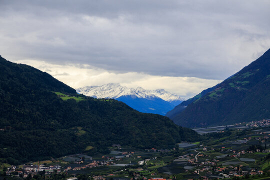 Mountain panorama with snowcapped mountains and summit Laaser Spitze (Orgelspitze) in Ortler Alps and valley Etschtal on a cloudy day in autumn in South Tyrol, Italy - Powered by Adobe