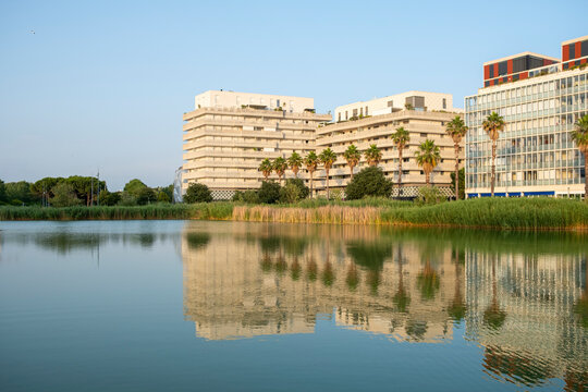 Large modern residential complex with mirrored water surface in Montpellier, reflecting sustainable design principles and environmental integration