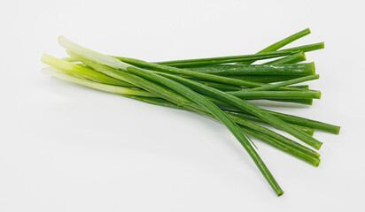 A bright bundle of green onions laid on a clean white background. Perfect for cooking, garnishes, salads, or healthy meal ideas and recipe visuals.