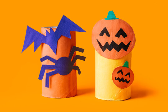 Halloween monsters from toilet paper roll tube, easy DIY handmade decorations idea. Paper toys zombie and vampire on yellow background. Kids creativity, easy eco craft, step by step, place for text