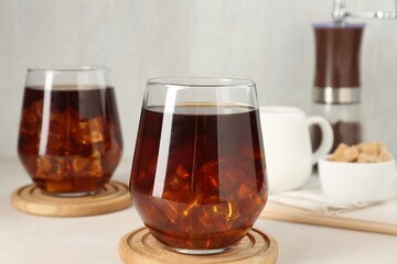 Tasty iced coffee on white table, closeup
