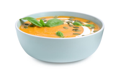 Delicious pumpkin soup with seeds and basil in bowl isolated on white