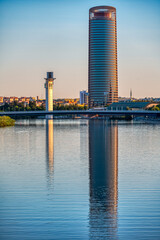 Reflections of Seville towers on the Guadalquivir River at sunset