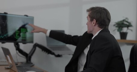 Financial analyst working on multiple monitors displaying stock market charts, financial data, and trading analytics. Intense trading environment for investment, finance, and technology - Powered by Adobe