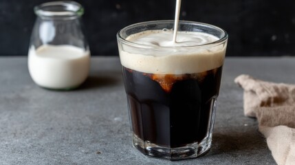 Pouring cream into iced coffee kitchen counter beverage photography cozy environment close-up view refreshing concept