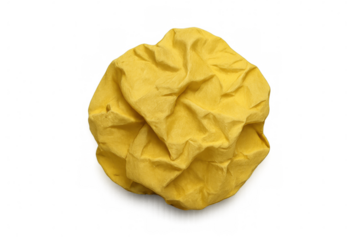 Crumpled yellow paper ball on transparent background representing mistake, failed idea, waste, or discard