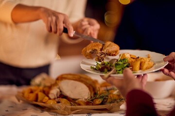 Warm Family Dinner Scene: Serving Roast Chicken, Potatoes, and Greens at New Year Celebration Gathering