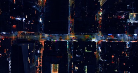 Descending above the roads and crossroads of the night city. Car and yellow taxi ride by the streets of never-sleeping New York.