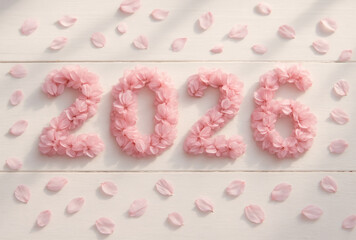 the inscription 2026 made from pink sakura petals