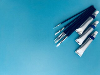 Set of painting supplies including paint tubes, brushes .Perfect for art, creativity, and design concepts.