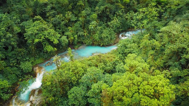 Turquoise river meandering through tropical rainforest valley in Costa Rica