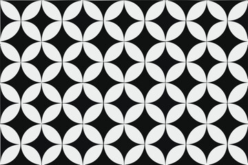 Fototapeta premium Monochrome pattern featuring interlocking white petal shapes on a black background forming