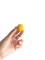 Delicate hand holding a vibrant yellow orange, symbolizing potential and precision in creation