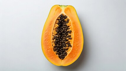 Fresh papaya halved revealing seeds and vibrant orange flesh