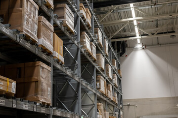 Interior view of a warehouse with stacked pallets and products ready for shipment. Logistics, storage, inventory, and delivery industry concept.