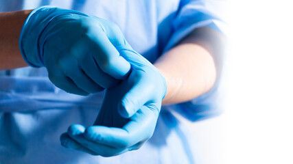Healthcare Professional Donning Blue Medical Gloves