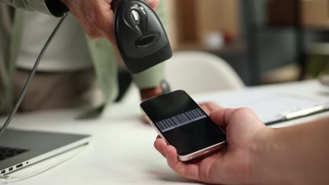A man is using a qr code reader to scan a code on a phone